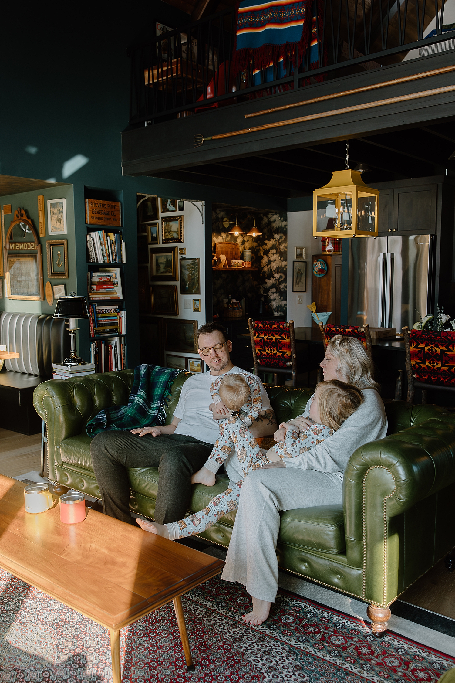 family of four on green couch by Samantha Burke Photography
