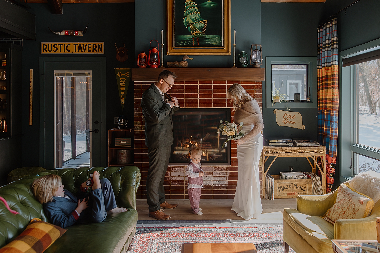husband and wife stand in front of fireplace for vows for airbnb elopement