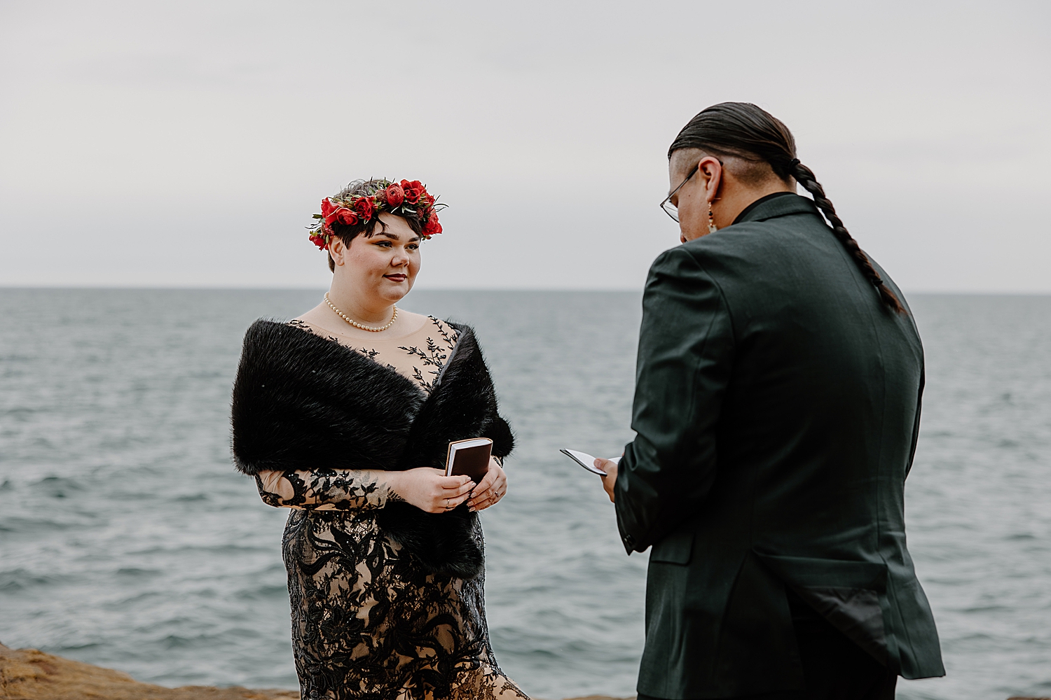 brunette looks lovingly at man while he reads vows by Samantha Burke Photography