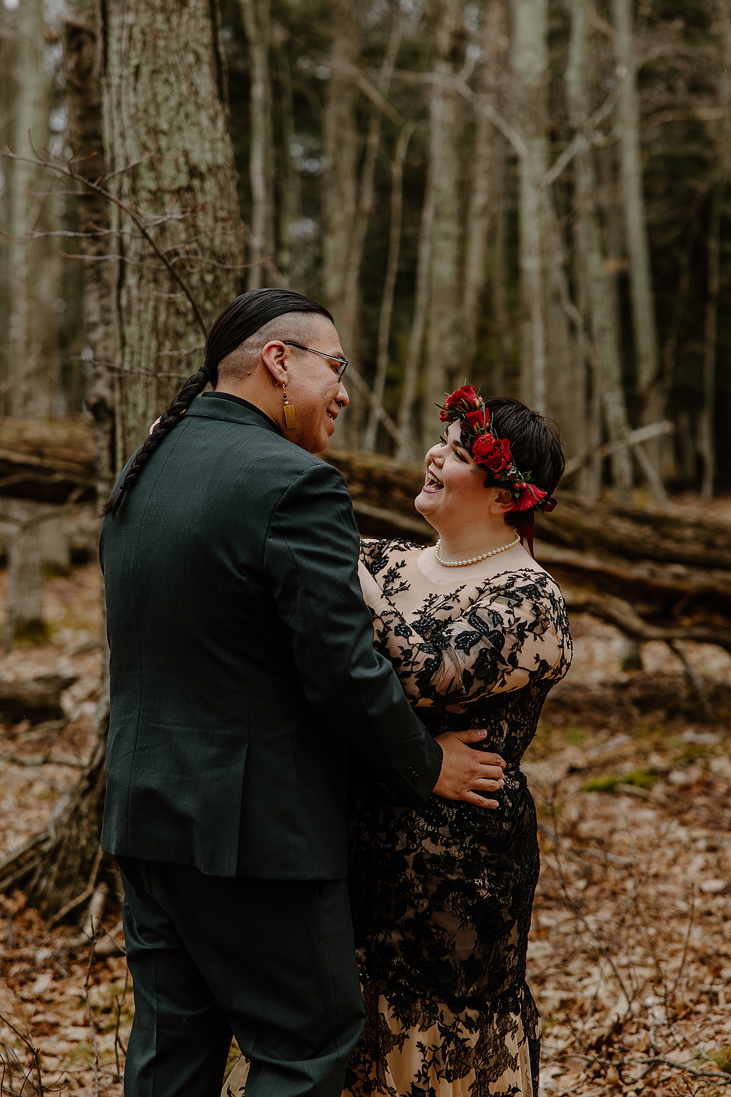 woman in red flower crown giggles with husband by Wisconsin wedding photographer