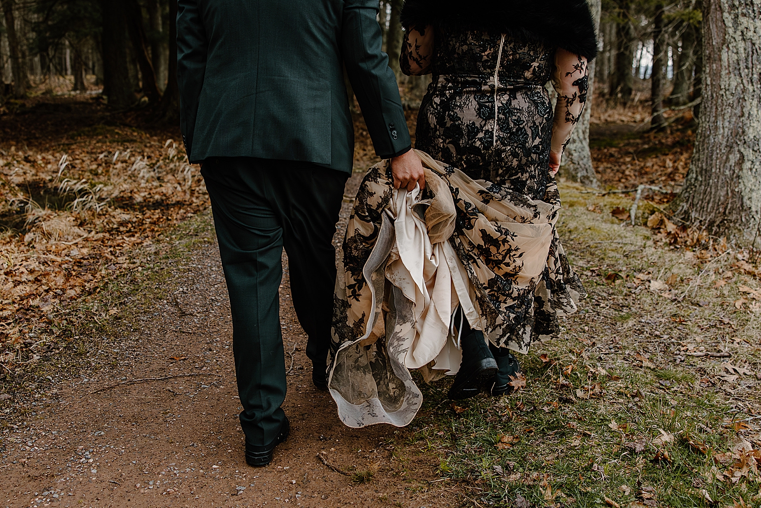 man carries wife's dress through trees for Beltane Elopement
