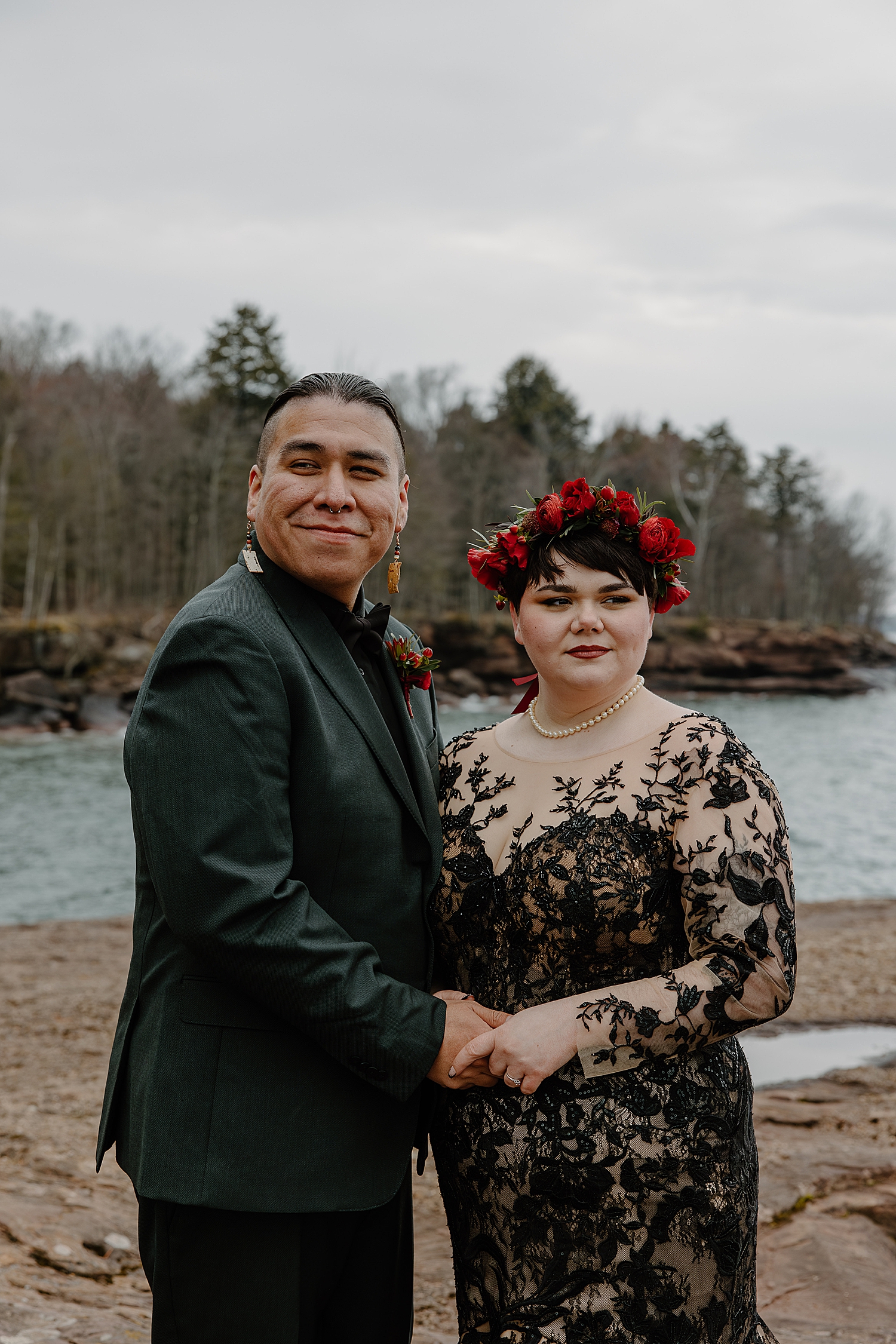 brunette with red flower crown holds her man's hands by Samantha Burke Photography