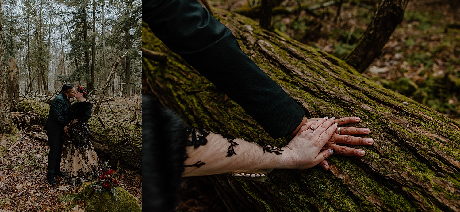 husband and wife place hands on moss covered log for Beltane Elopement