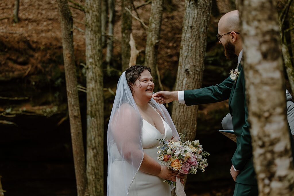 man leans out to caress his bride's chin by Minnesota elopement photographer