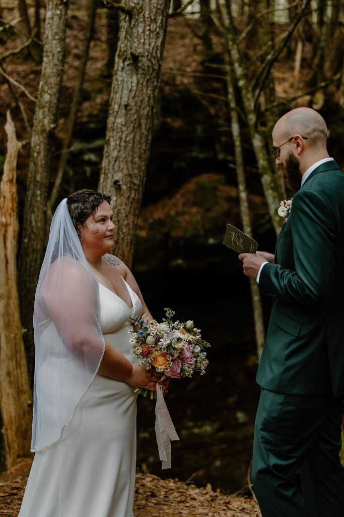 groom reads his vows during private ceremony by Samantha Burke Photography