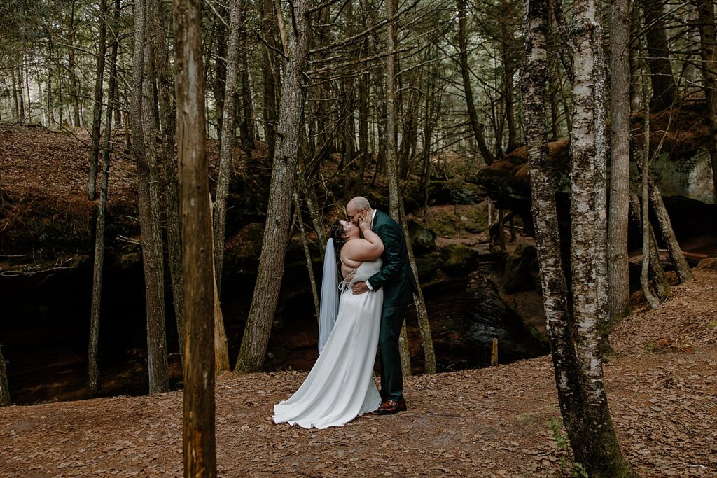 husband and wife share first kiss during Intimate Ceremony at Houghton Falls