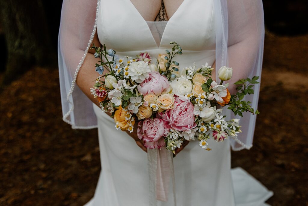pink, white and cream bridal bouquet by Minnesota elopement photographer