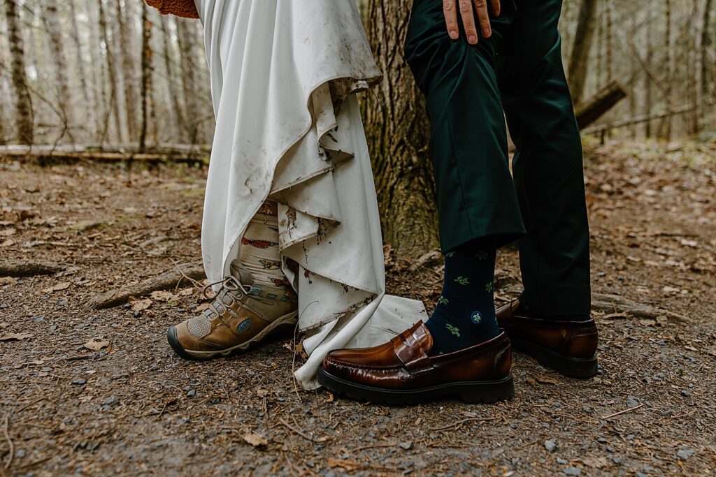 man and woman show off muddy shoes at Intimate Ceremony at Houghton Falls