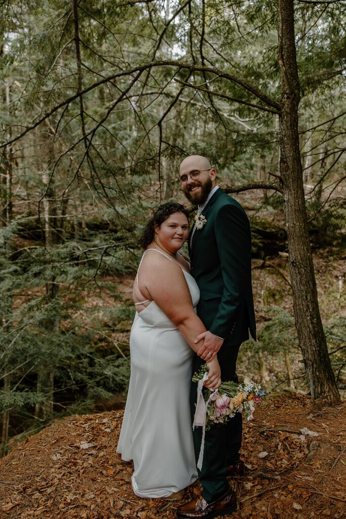 couple grins after they said I Do in forest by Minnesota elopement photographer
