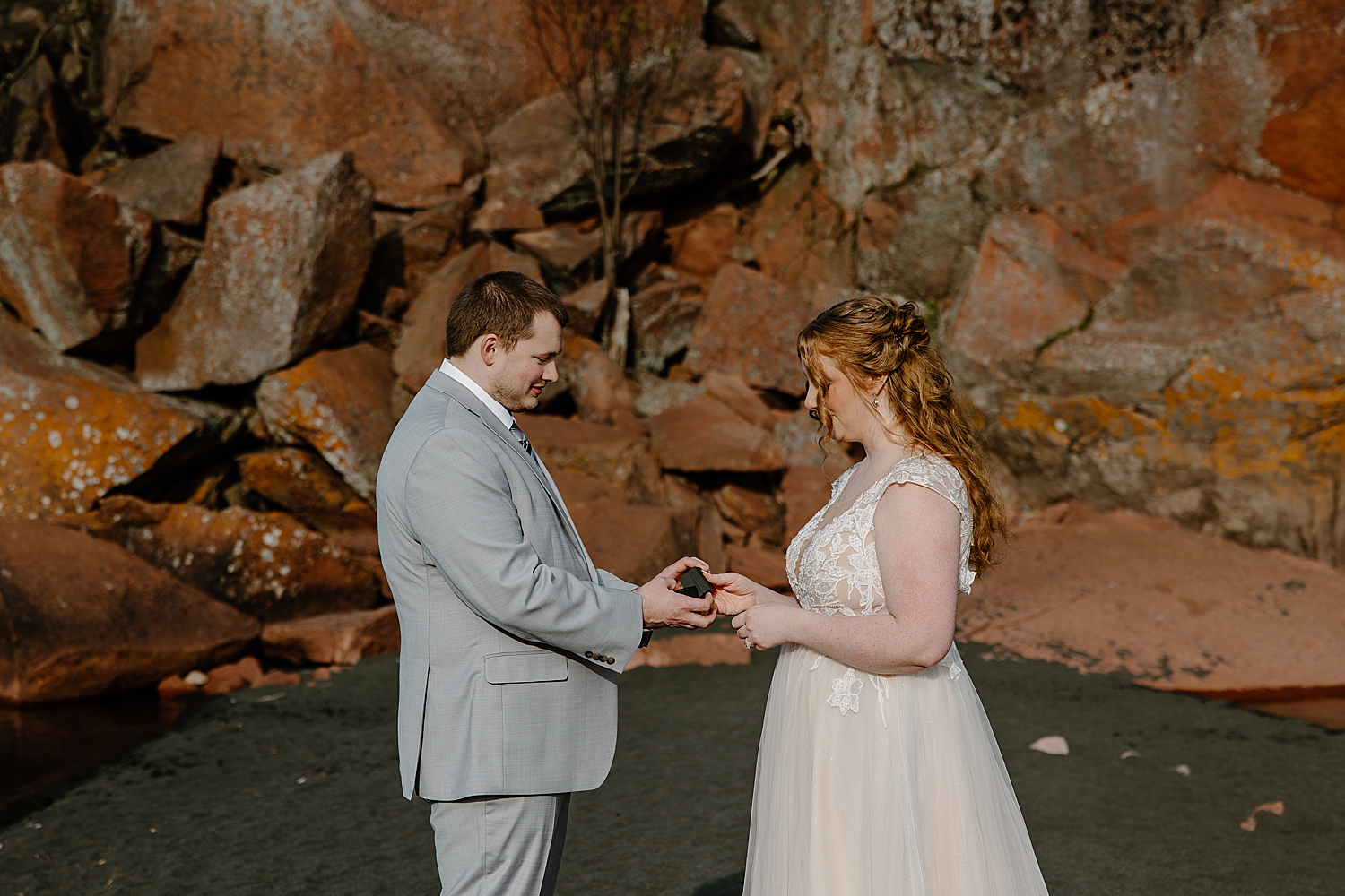 man gives his new wife a ring in small ceremony by Minnesota Elopement Photographer