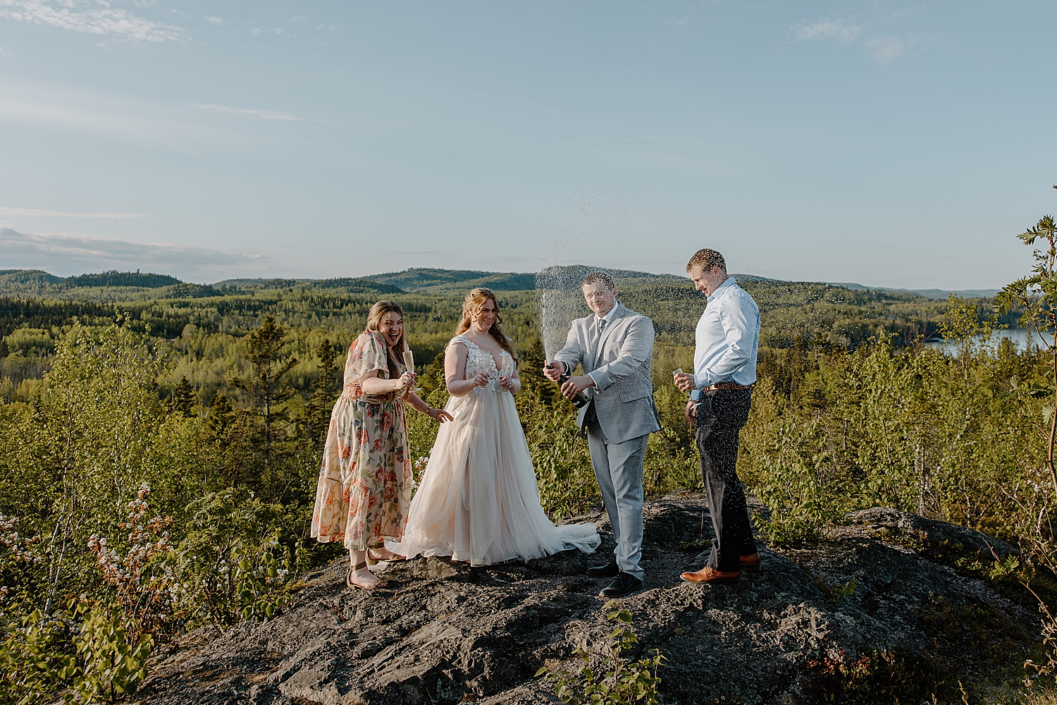 newlyweds share champagne with friends by Minnesota Elopement Photographer