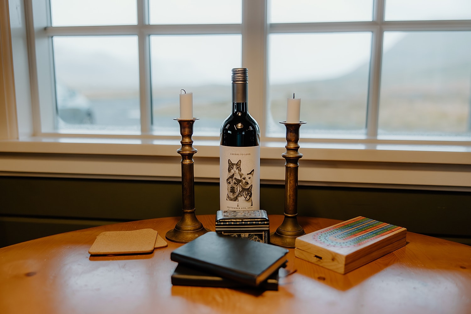 wine bottle on table with two candlesticks showing how to include pets in your elopement