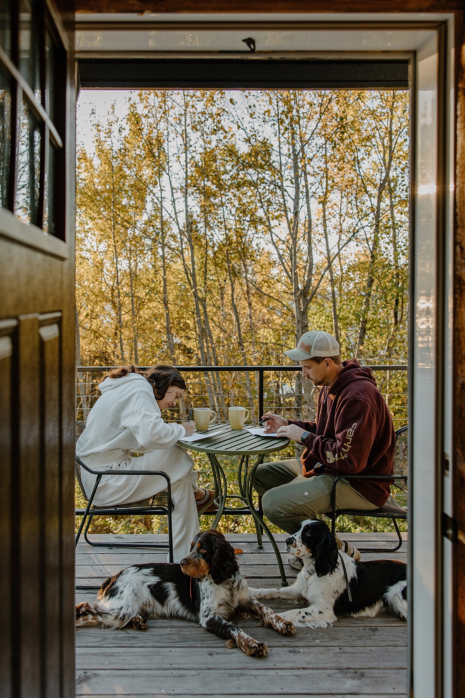 couple enjoys morning coffee on the porch showing how to include pets in your elopement