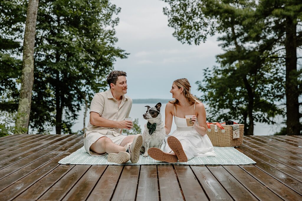 couple enjoys a deck picnic with spotted mutt by Samantha Burke Photography