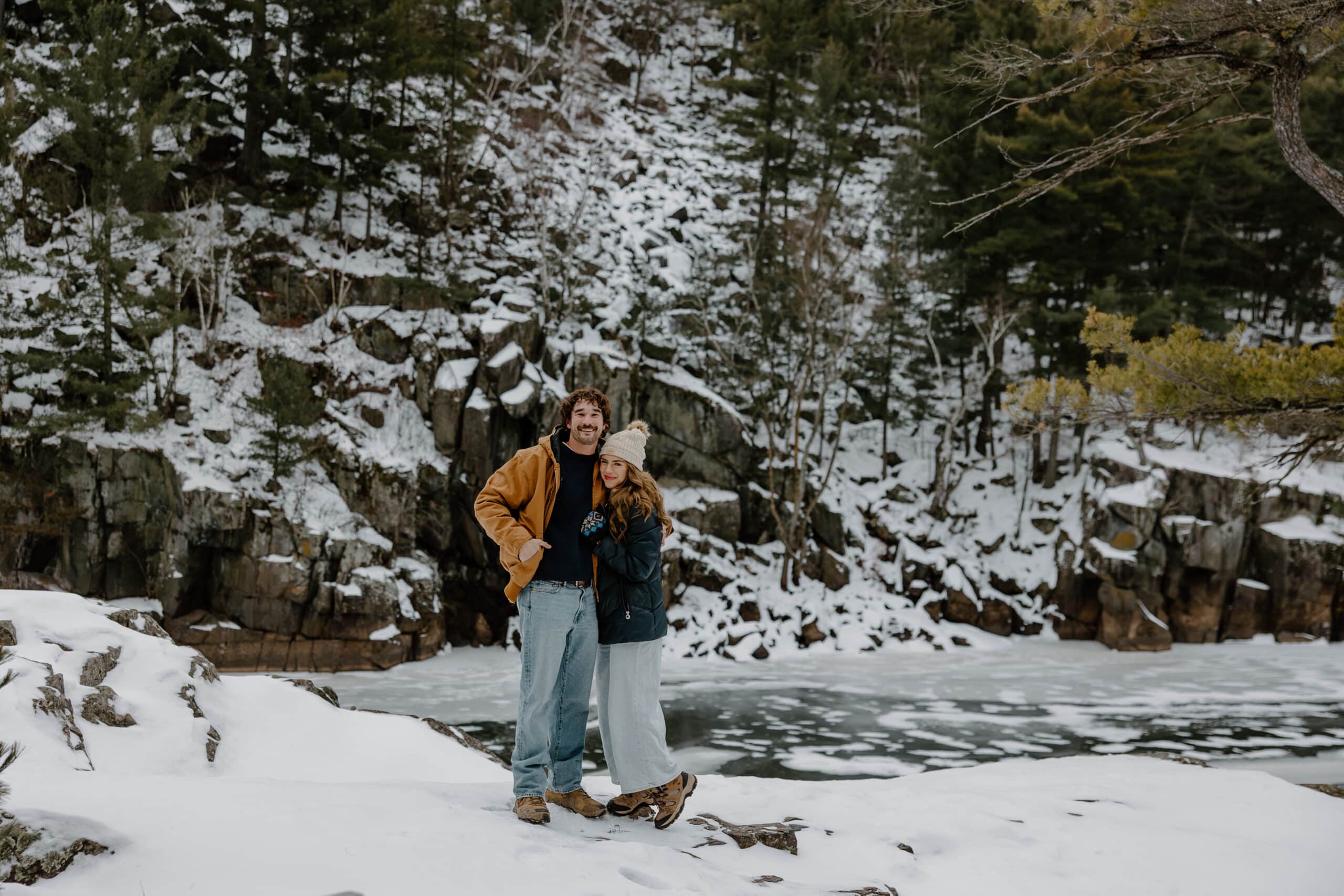 couple snuggle together in the cold by Wisconsin wedding photographer