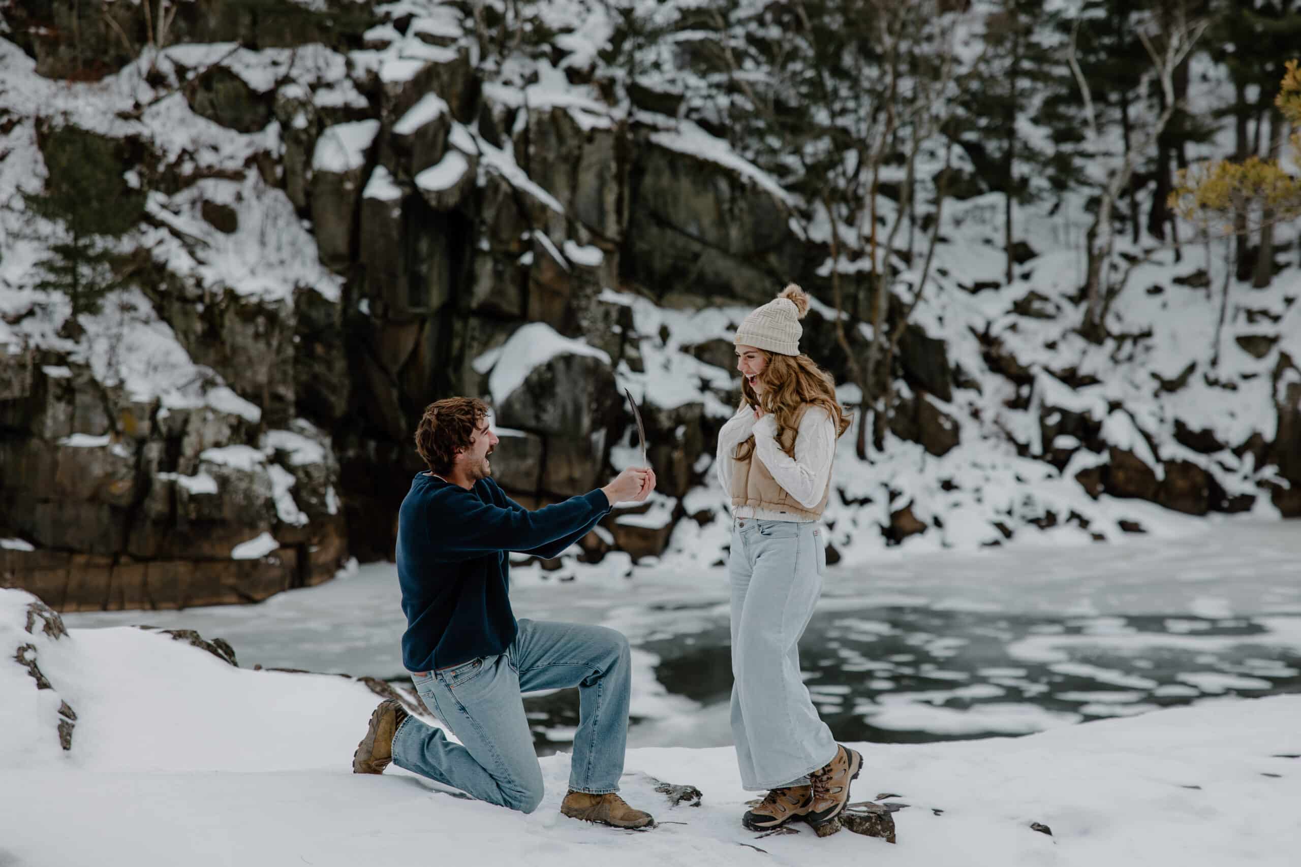 groom-to-be kneels in the cold to ask a question by Samantha Burke Photography