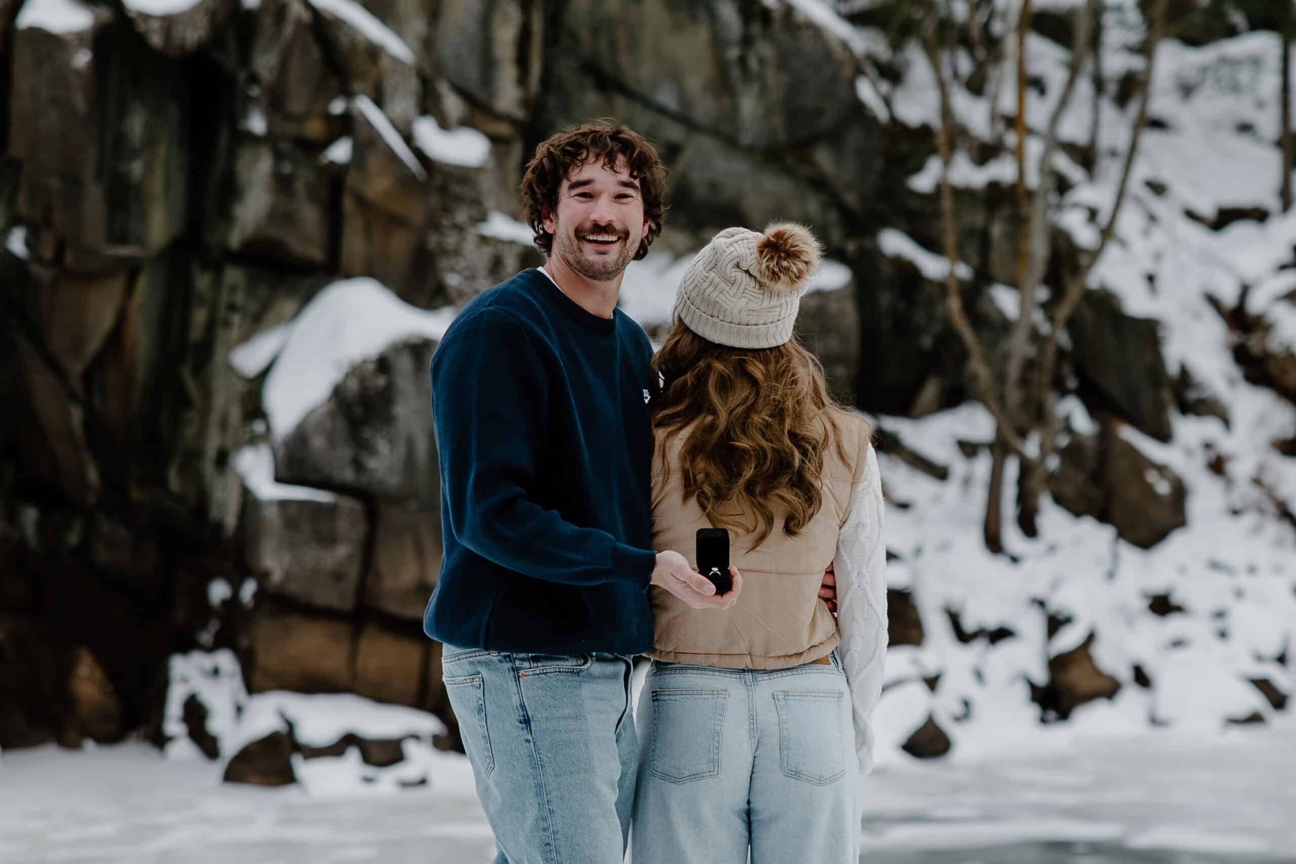 man shows ring behind woman's back for Interstate State Park Winter Proposal