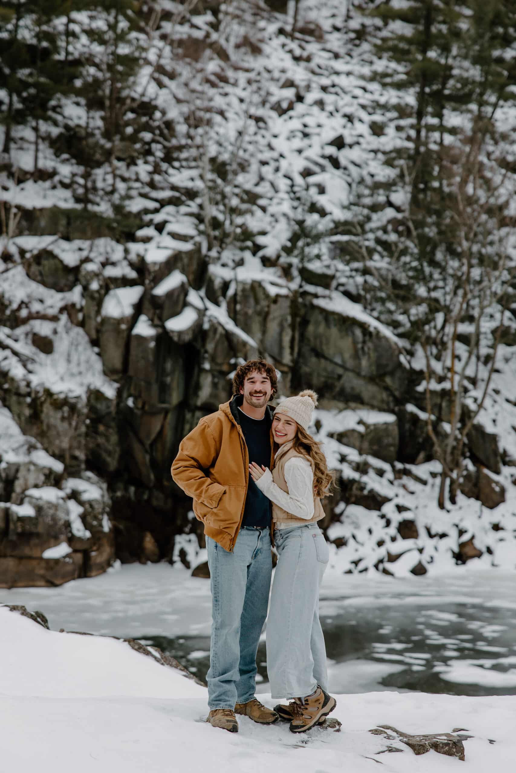 blonde woman snuggles up to her man in the cold by Samantha Burke Photography