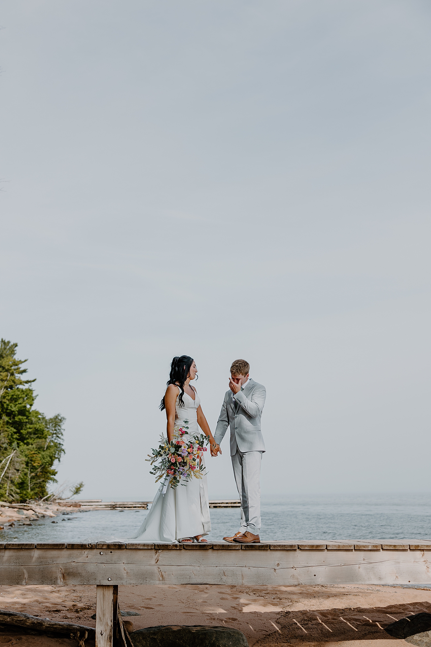 man cries during first look for Lake Superior intimate wedding