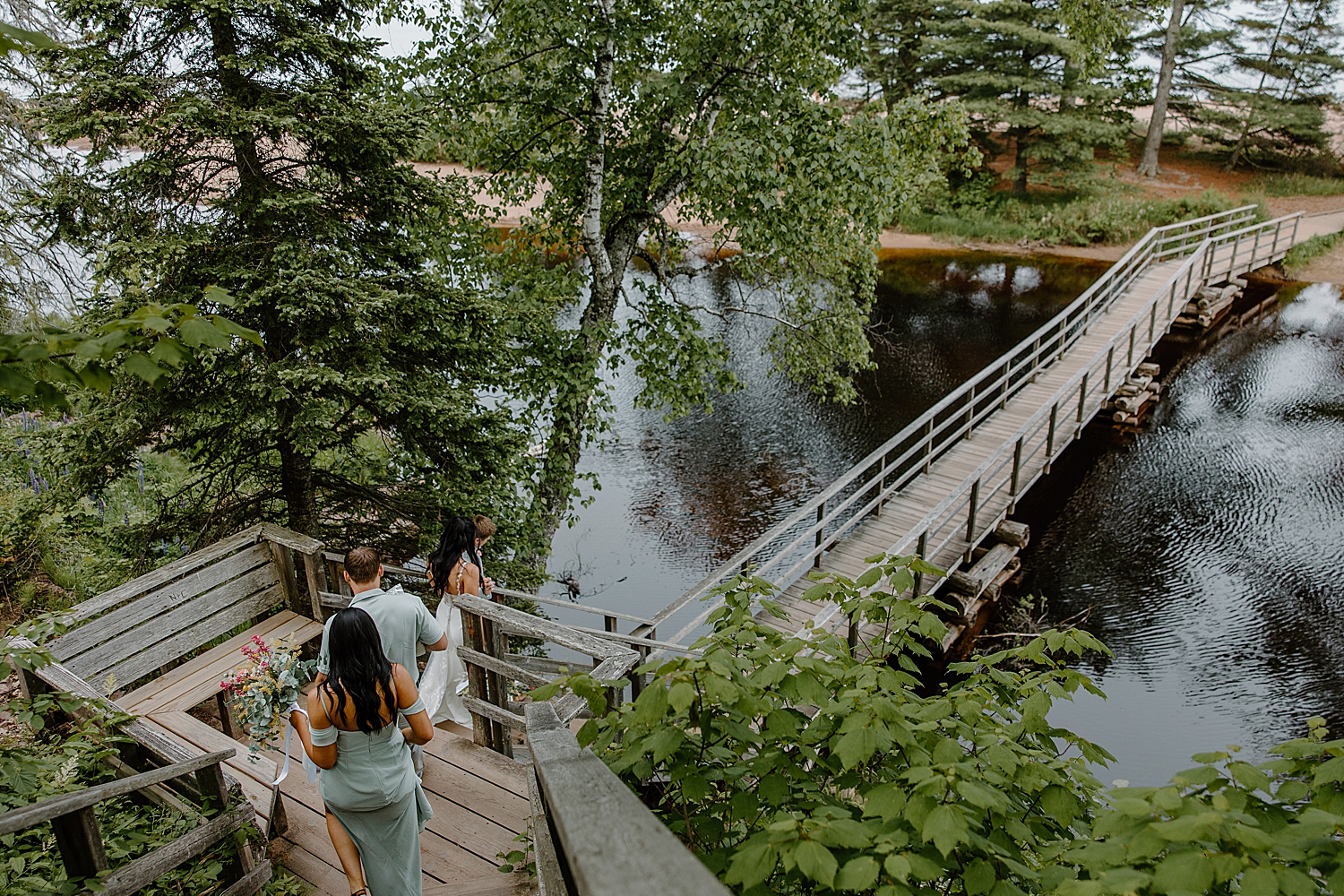 small group heads down stairs outside for Lake Superior intimate wedding