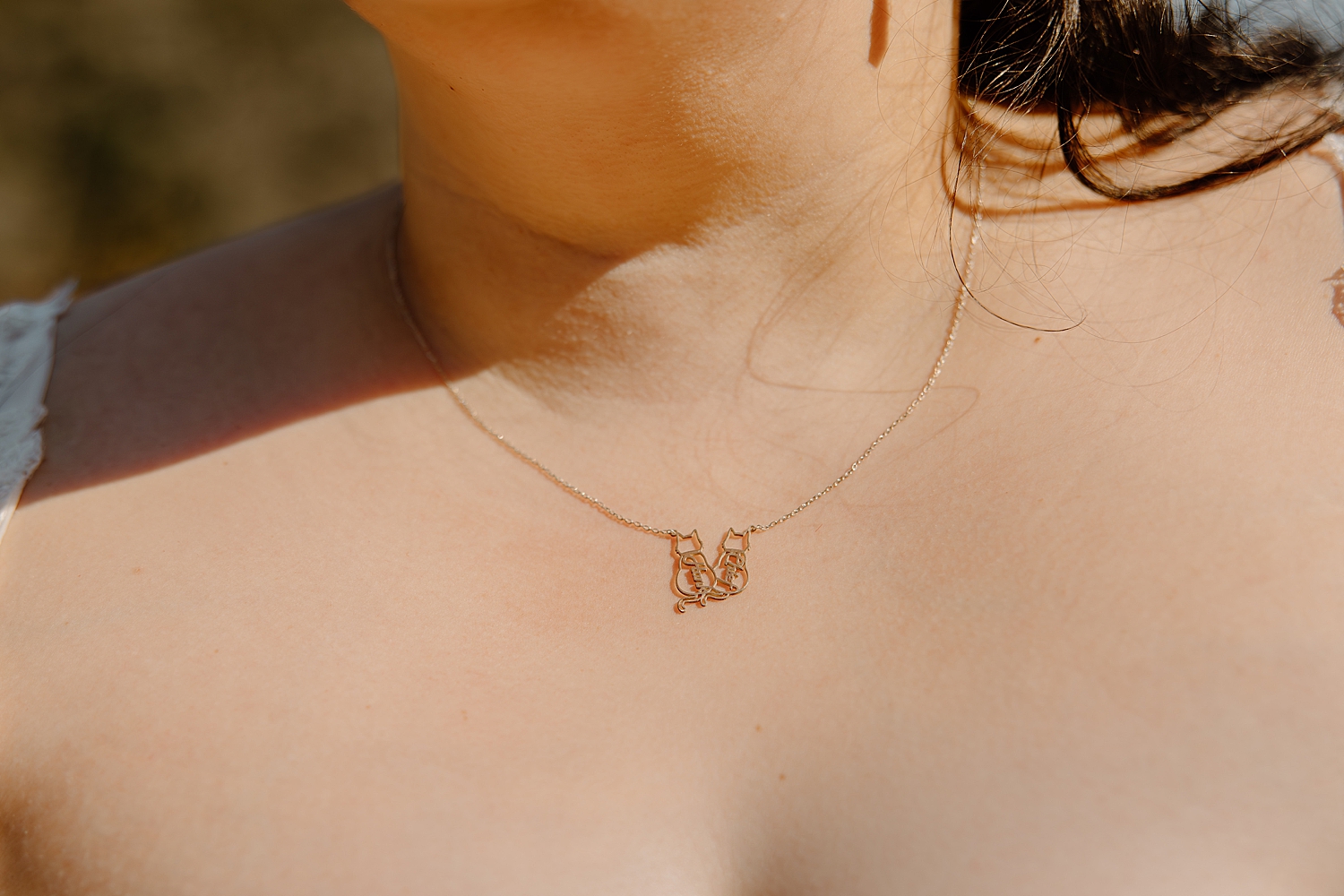 bride shows off her custom cat necklace for details to make your elopement even more special