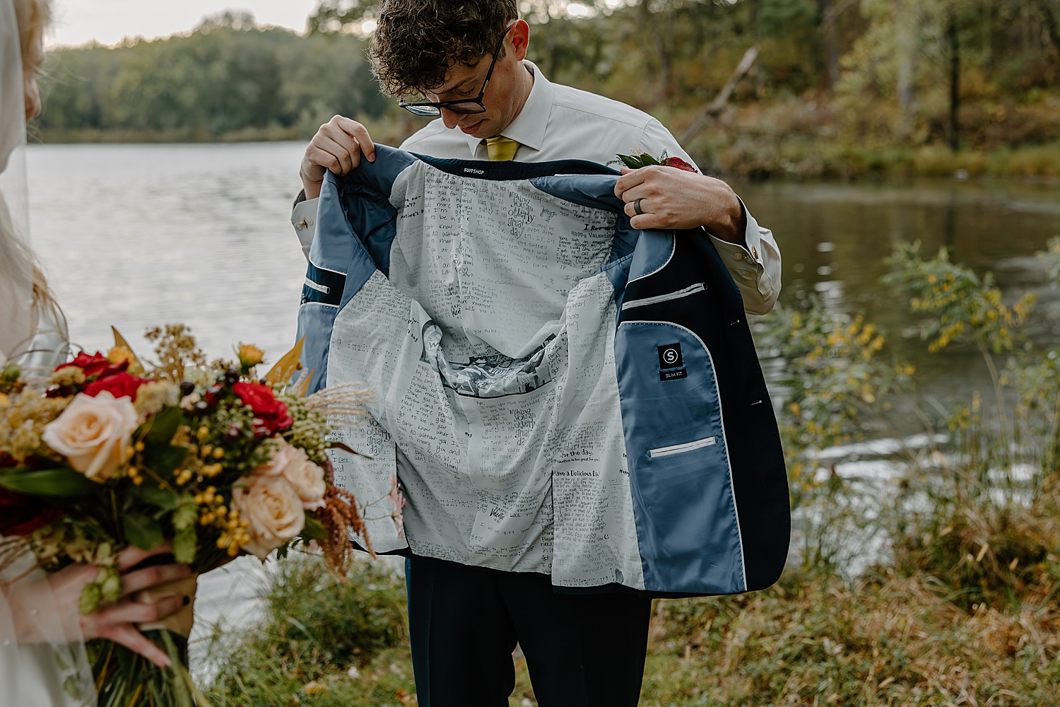 groom shows off custom jacket with love letters from bride by Wisconsin wedding photographer