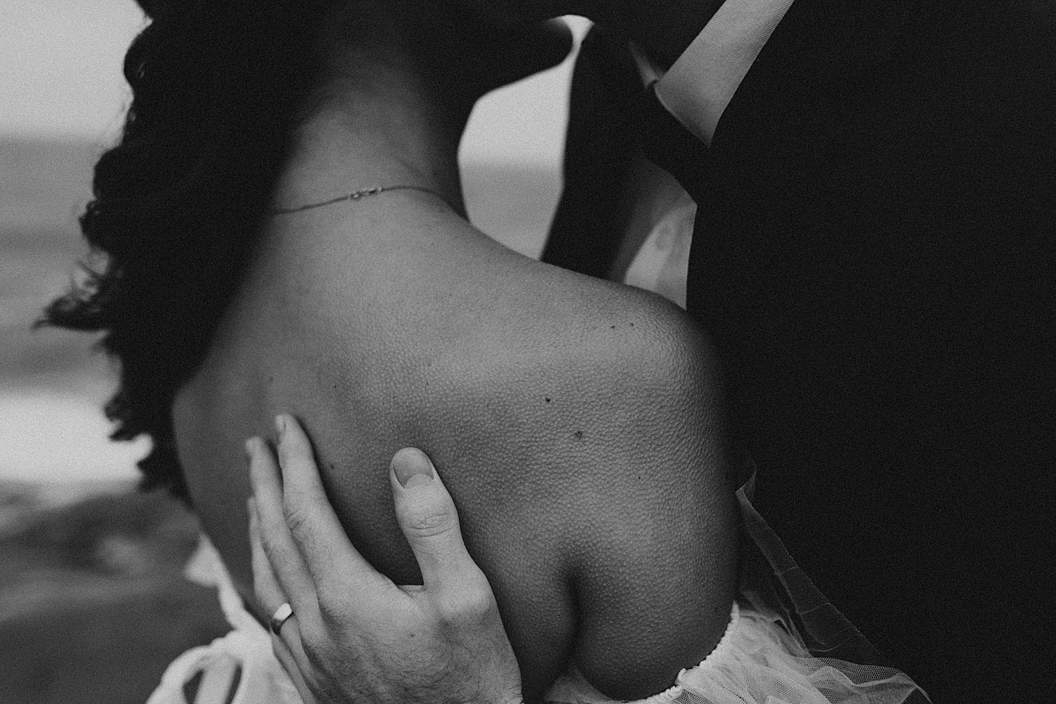 groom holds bride showing details to make your elopement even more special