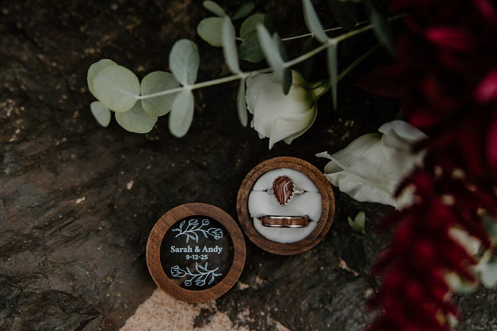 two agate rings in box on log showing details to make your elopement even more special